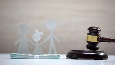 Paper family cutout beside a gavel
